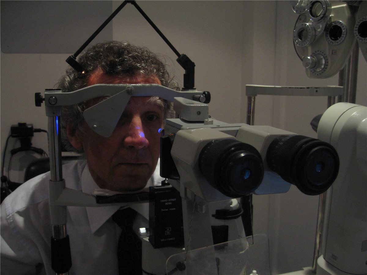 Goldmann Applanation Tonometry - tonometer mounted on the slit lamp Goldmann applanation tonometry: a patient positioned at a Haag-Streit slit lamp with the Goldmann tonometer prism in place and the cobalt blue illumination activated for intraocular pressure measurement